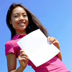 Image showing Girl with blank sign in field