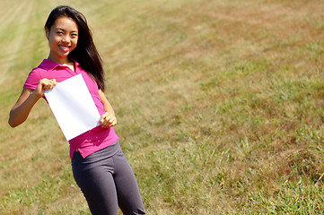 Image showing Girl holding a sign