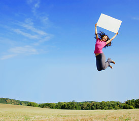 Image showing Girl Jumping With Sign
