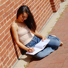 Image showing Girl Writing In Note Book