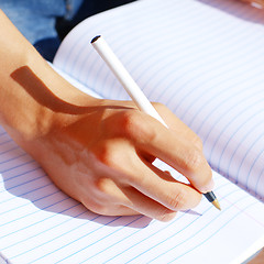 Image showing Girl Writing In Note Book