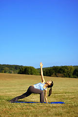 Image showing Girl Practicing Yoga In Field