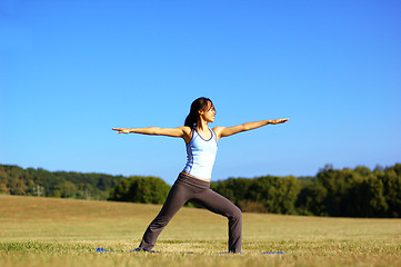 Image showing Girl Practicing Yoga In Field