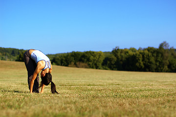 Image showing Girl Practicing Yoga In Field