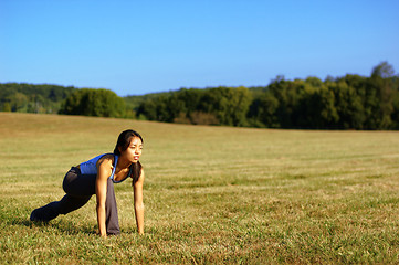 Image showing Girl Practicing Yoga In Field