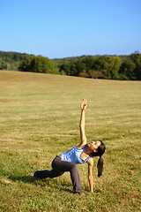 Image showing Girl Practicing Yoga In Field