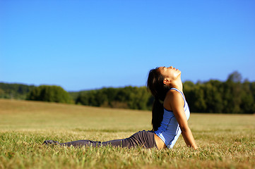 Image showing Girl Practicing Yoga In Field