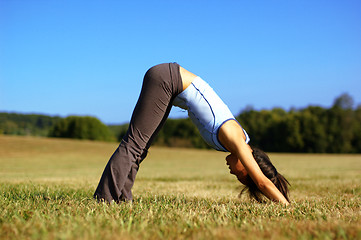 Image showing Girl Practicing Yoga In Field