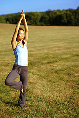 Image showing Girl Practicing Yoga In Field