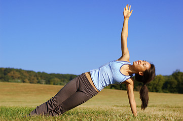 Image showing Girl Practicing Yoga In Field