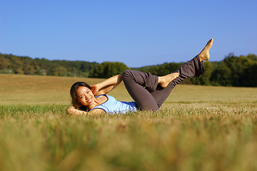 Image showing Girl Practicing Yoga In Field