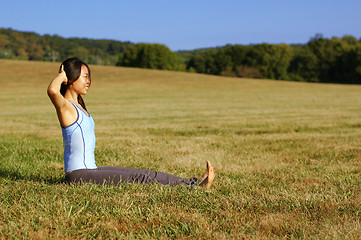 Image showing Girl Practicing Yoga In Field