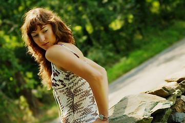 Image showing Pretty Girl Next to Stone Fence