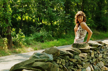 Image showing Pretty Girl Next to Stone Fence