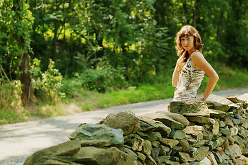 Image showing Pretty Girl Next to Stone Fence