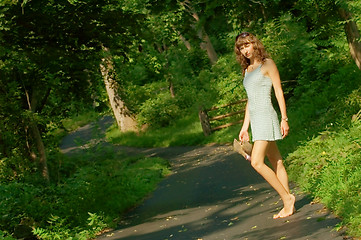 Image showing Pretty girl on forest path