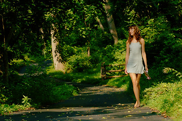 Image showing Pretty girl on forest path