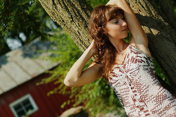 Image showing Girl Leaning Against Tree