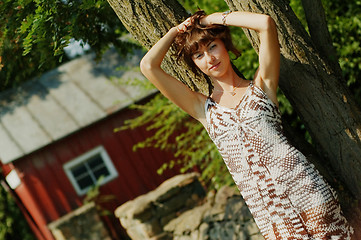 Image showing Girl Leaning Against Tree