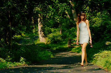 Image showing Pretty girl on forest path