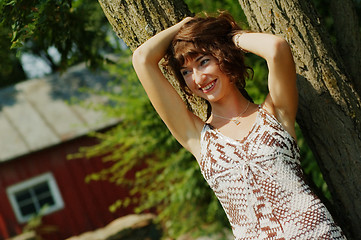 Image showing Girl Leaning Against Tree