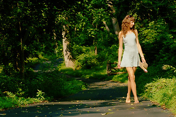 Image showing Pretty girl on forest path