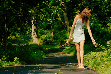 Image showing Pretty girl on forest path
