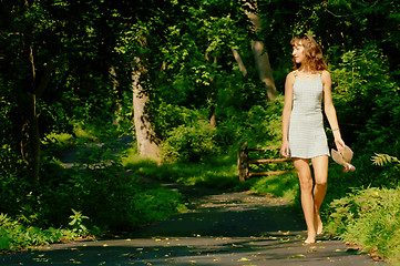 Image showing Pretty girl on forest path