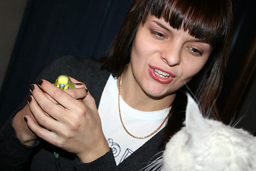 Image showing younger woman and green parrot