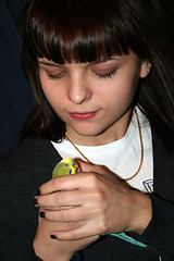 Image showing younger woman and green parrot