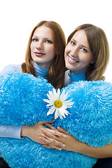 Image showing Two woman sit with camomile and teddy heart