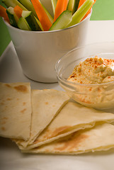 Image showing hummus dip with pita bread and vegetable