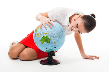 Image showing Business woman searching county on the globe