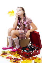 Image showing  kid sitting holding maple leaf with gramophone