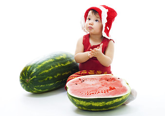 Image showing Baby with red dress and cap sit with watermelon