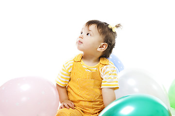 Image showing Happy baby with baloons on her first birthday