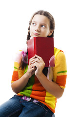 Image showing Pensive teenager girl with book