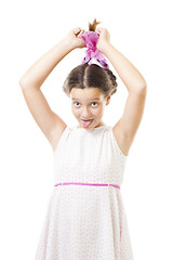 Image showing Girl in pink play the fool stick her tongue