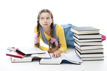 Image showing clewer teenager girl lay with books