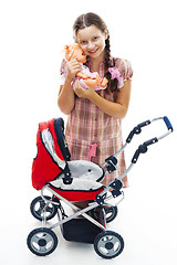 Image showing Girl play with buggy and doll