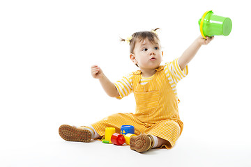 Image showing Kid play sit and with toys, holding pail