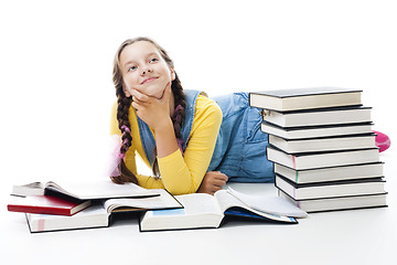 Image showing Young teen girl lay with many books 