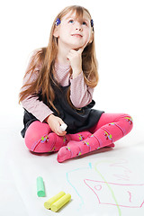 Image showing LIttle girl thinking and drawing