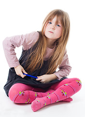 Image showing Little girl sit with felt pen with intense face