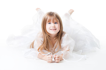 Image showing Little girl wear dress lay on the floor