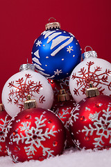 Image showing Christmas balls over a red background