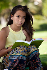 Image showing child reading a book at the park