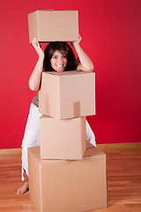 Image showing Woman holding cardboard boxes