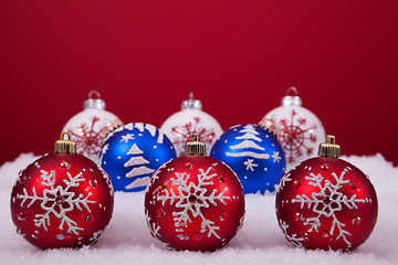 Image showing Christmas balls over a red background