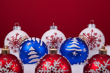 Image showing Christmas balls over a red background